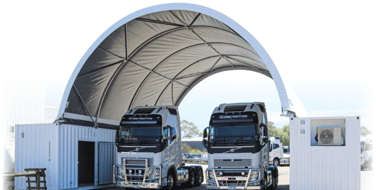 A fabric-covered shelter designed for trucks, supported by container-mounted structures with integrated storage.