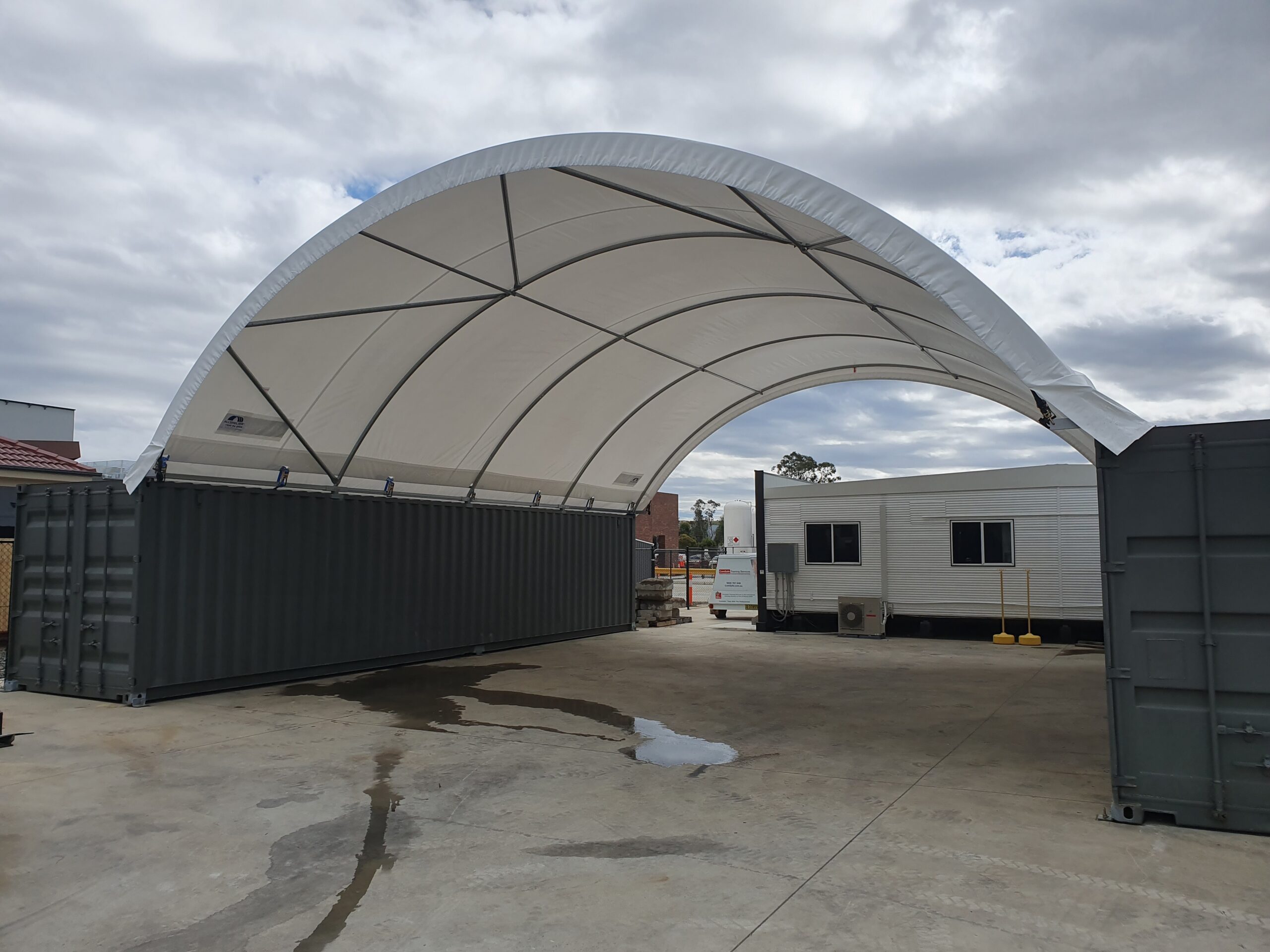 Image of a domed fabric shelter on containers.